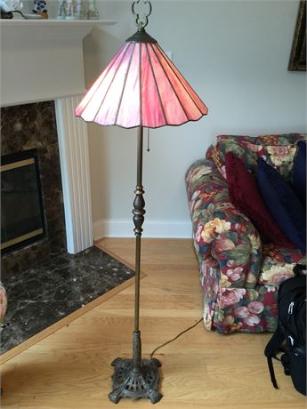 Brass colored floor lamp with pink shade