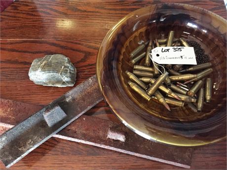 Lot 375.  Amber Bowl of Bullet Shells, Rock Paperweight and Metal Post Fragments