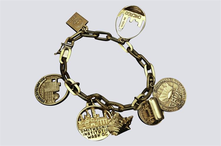 Gold Chain-link Charm Bracelet with Seven Charms.