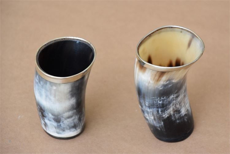 Water  buffalo horn cups with silver rims.