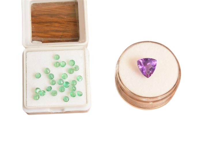 Group of loose stones:  25 tiny emeralds and one triangular cut amethyst.