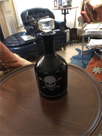Black and clear glass decanter with skull motif etched on both sides