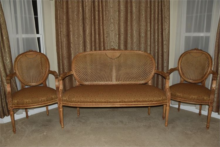 Carved and Gilt Settee and Pair Of Armchairs With Cane Back and Upholstered Seat