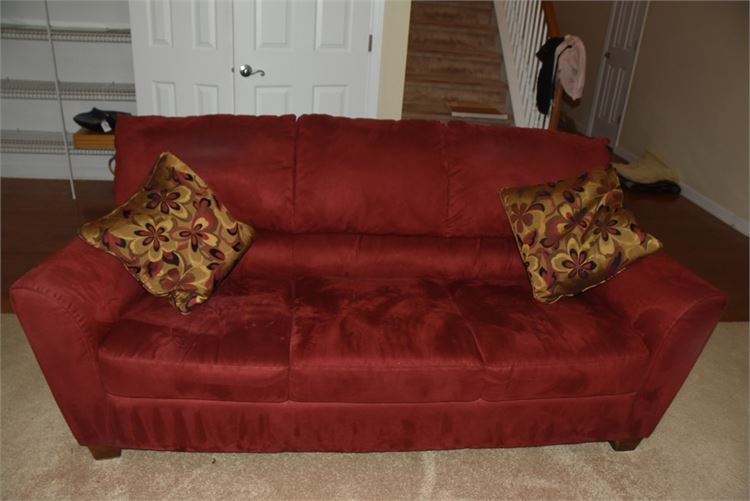 Contemporary Red Sofa With Patterned Decorative Pillows