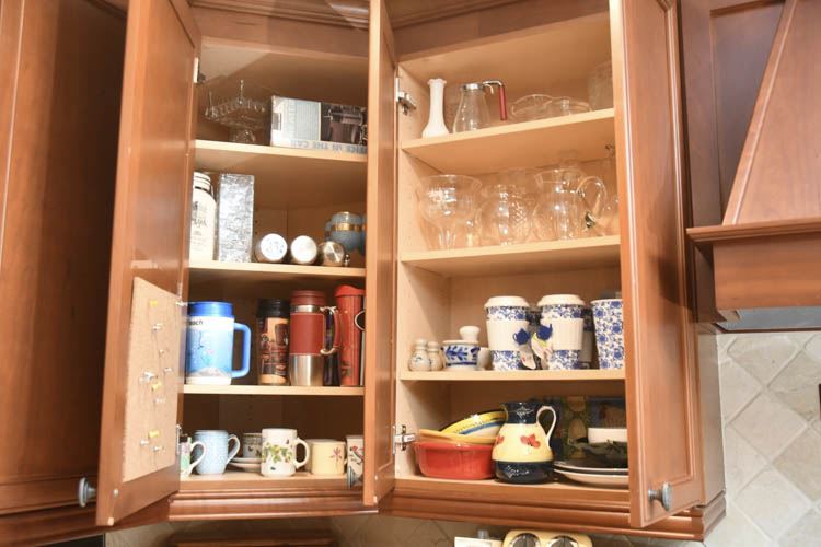 Glasses, cups and utilitarian items located in Two Cabinets