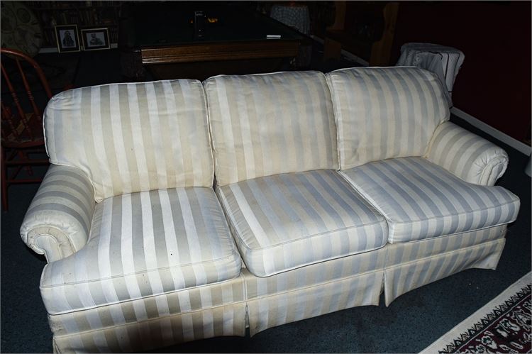 White Sofa with Throw Pillows and Textiles