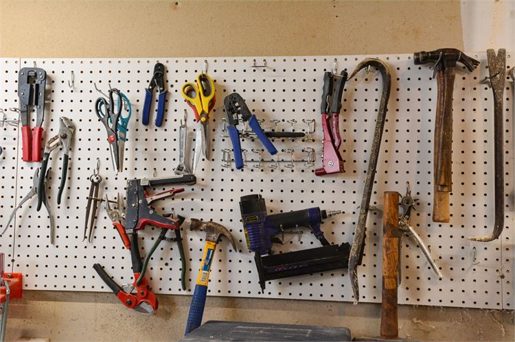 Pegboard Wall Full of Tool: Pliers, Scissors, Hammer