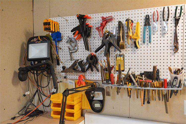 Workshop Wall with Tools: Clamps, Pliers, and Screwdrivers and a Work Light