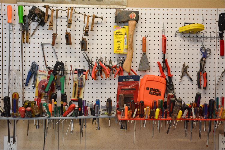 Pegboard Wall Full of Tools: Screwdrivers, Pliers and an Axe