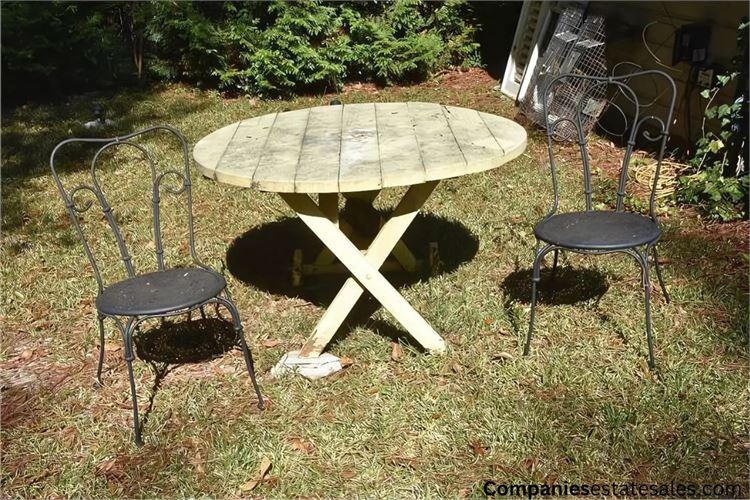 Light Yellow Round Table and Two Black Metal Chairs